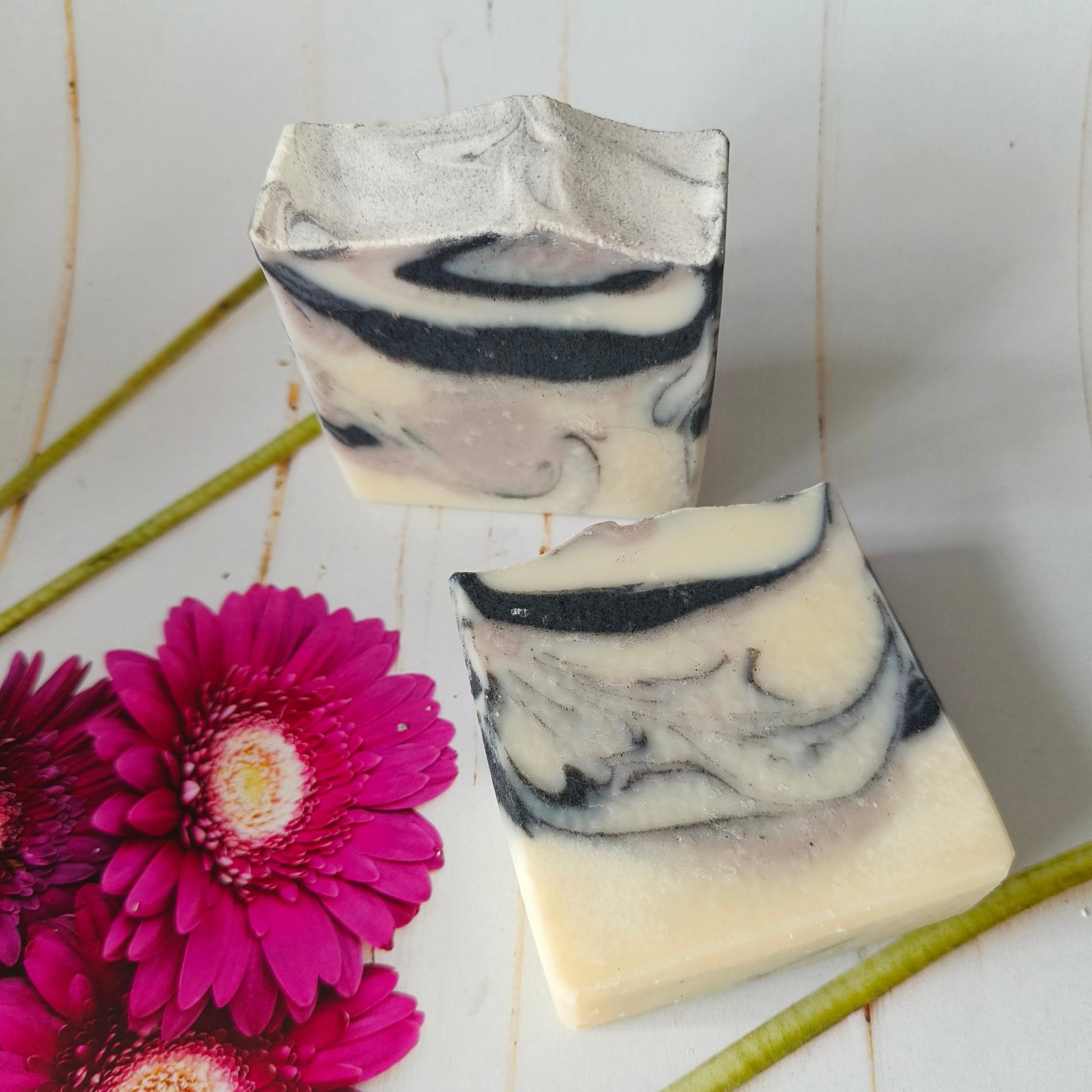 Two bars of lavender & cedarwood spa soap with purple clay and charcoal in gentle swirls